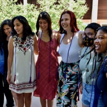 group of people smiling and standing closely 