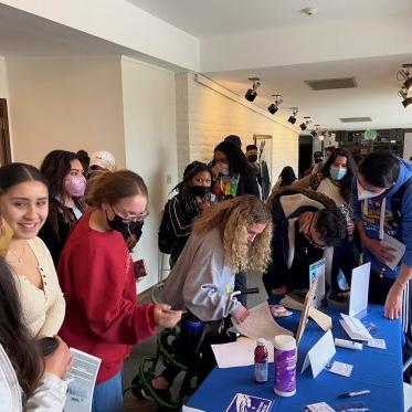 group of students standing around a table